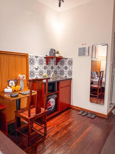 a kitchen with a counter and a table and a chair at La Casa Di Dicembre 18 Hàng Cháo in Hanoi