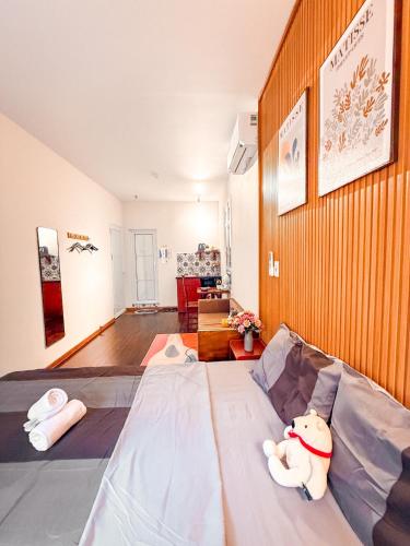 a room with a bed with a stuffed animal on it at La Casa Di Dicembre 18 Hàng Cháo in Hanoi