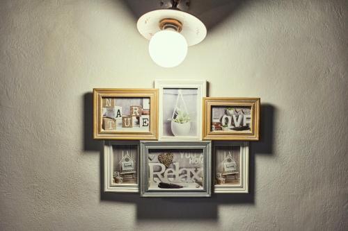a group of framed pictures on a wall at La casina in Via Fiorita in Montepulciano