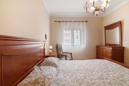 a bedroom with a bed and a dresser and a mirror at Mar Salgado Beach Apartment in Armação de Pêra