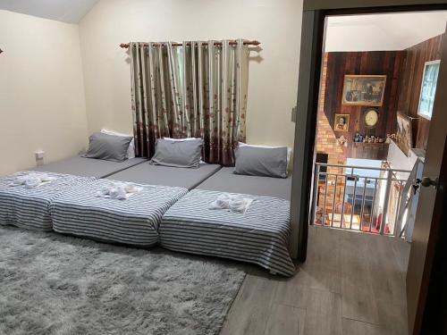 a bedroom with two dogs laying on a bed at ตอไม้คันทรีรีสอร์ท in Ban Maklua Mai