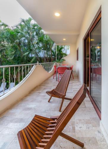 a balcony with two benches and a table at Casa Riviera in Bucerías