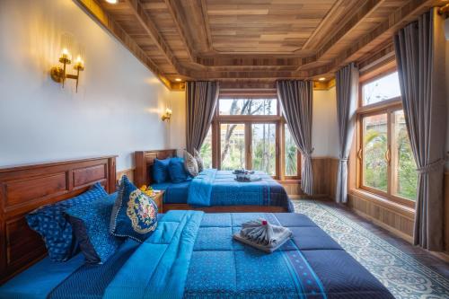 a bedroom with two beds with blue sheets at KNN Luxury Hill in Sen Monorom