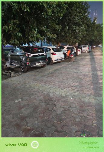 a row of parked cars in a parking lot at Nainital Cotteges in Rāmgarh