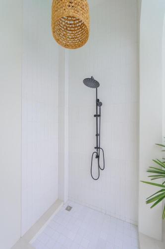 a shower in a white bathroom with a light at Balina Private Pool Villa in Ban Chin Tham Mai