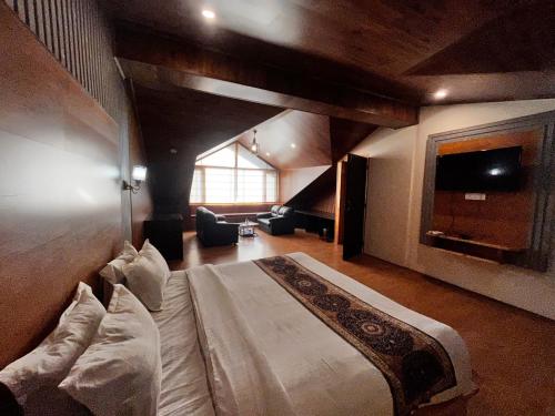 a bedroom with a large bed in a room at Jubilant Farm House in Rishīkesh