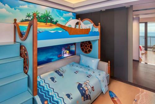 a bedroom with a bunk bed with a pirate ship mural at Dusit Thani Shuangyue Bay Resort Huizhou in Huidong