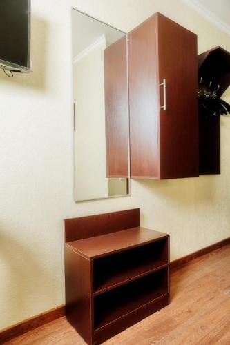 a cabinet and a mirror in a room at Панський Двір 2 in Chernivtsi