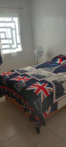a bedroom with a bed with a british blanket at Casa in Zacatecas