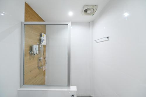 a shower with a mirror in a bathroom at Mina Resort and Spa in Loei