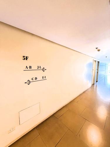 a wall with a writing on it in a room at JFam Suites, C1-5L 1BR , Up To 7 Pax in Biñan
