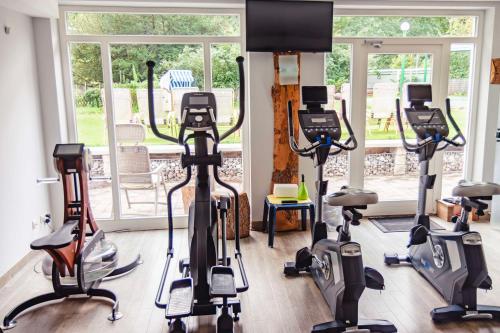 a gym with treadmills and elliptical machines at Best Western Plus Ostseehotel Waldschloesschen in Prerow