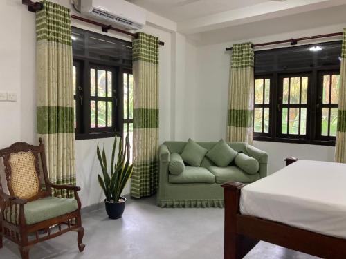 a living room with a couch and a chair at Penthouse Galle in Galle