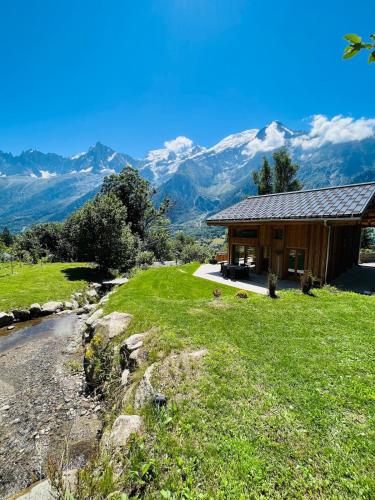 a house on a hill with mountains in the background at Chalet Croc Blanc, Chamonix - vu massif exceptionnel in Les Houches