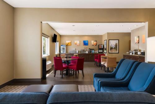a living room with a couch and a dining room at Comfort Inn Wichita East in Wichita