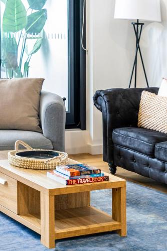 a living room with a couch and a coffee table at Wonderful Wollongong with Parking in Wollongong