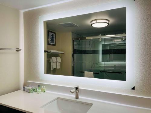 a bathroom with a sink and a large mirror at Quality Inn & Suites Lake Charles South in Lake Charles