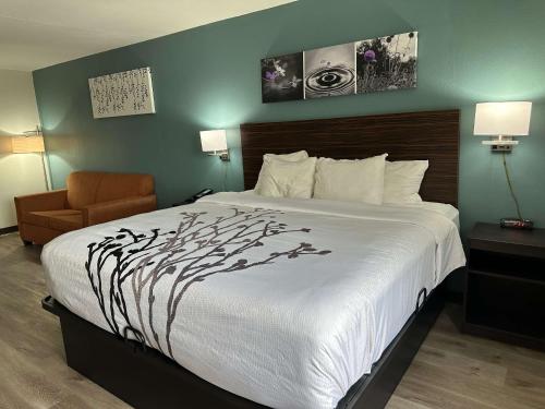 a hotel room with a bed and a chair at Sleep Inn & Suites Pineville - Alexandria in Pineville