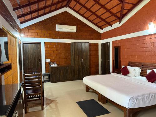 a bedroom with a bed in a red brick wall at Coffee Grove Resort in Chikmagalūr