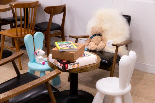 a table with stuffed animals and books on it at Bread Hill Hotel Jongno in Seoul