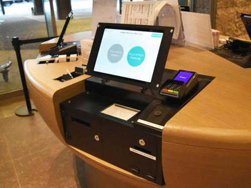 a cash register with a computer on top of it at SAPPORO HOTEL by GRANBELL in Sapporo