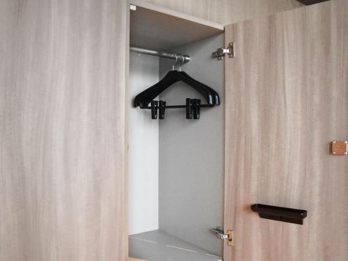 a closet with a door and a hanger at SAPPORO HOTEL by GRANBELL in Sapporo