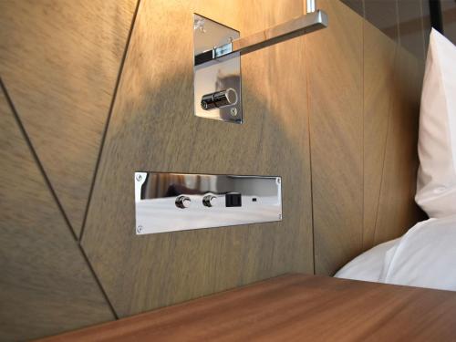 a hotel room with a bed and a pair of glasses at SAPPORO HOTEL by GRANBELL in Sapporo