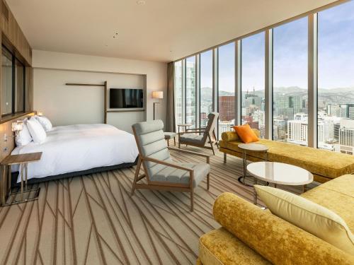 a hotel room with a bed and a large window at SAPPORO HOTEL by GRANBELL in Sapporo