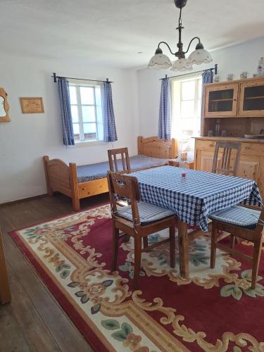 a dining room with a table and chairs and a kitchen at Adlerhütte in Stall