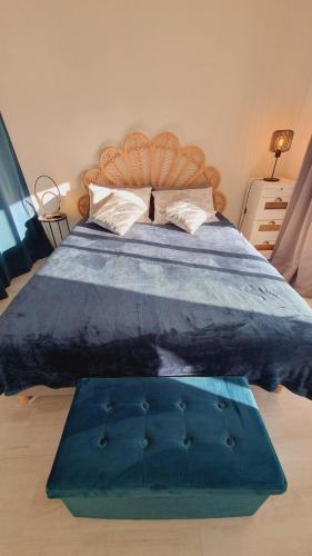 a bedroom with a large bed with a blue comforter at T2 West CITY Parking Clim Wifi 4pers - ROSSIconciergerie - Linge inclus in La Grande-Motte
