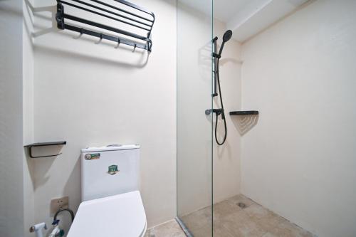 a bathroom with a toilet and a shower at 鼓浪屿古巷别苑旅馆 in Xiamen
