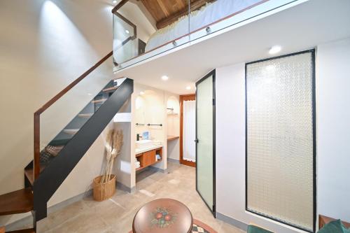a staircase in a house with a glass door at 鼓浪屿古巷别苑旅馆 in Xiamen