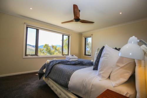 a bedroom with a bed with a ceiling fan at Kangaroo Lodge in Bright
