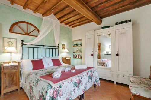 a bedroom with a bed with stuffed animals on it at Francigena in Gambassi Terme