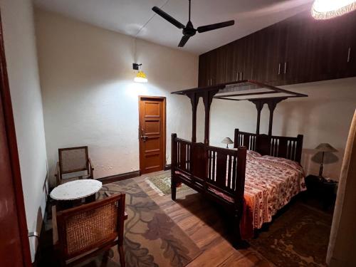 a bedroom with a bed and a ceiling fan at Aanandit aashiyana - A Blissful Place in Dehradun