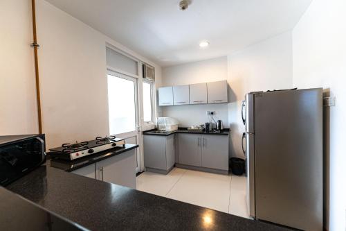 a kitchen with a stainless steel refrigerator at Oceanfront Condominium - Nilaveli in Nilaveli