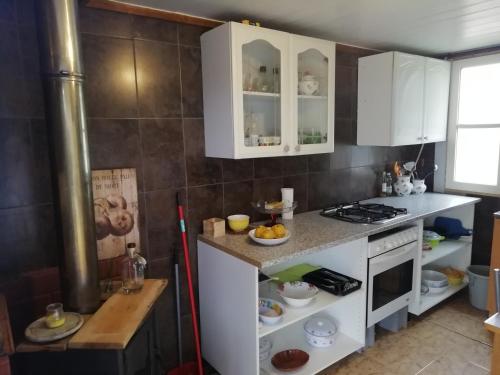 a kitchen with white cabinets and a stove at Monte da Luz in Alqueva
