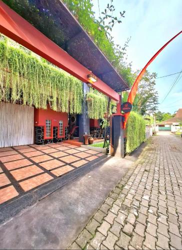 a patio of a house with a red roof at Villa Jogja Tropical in Yogyakarta