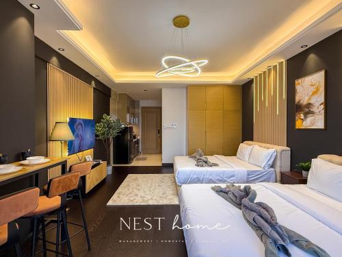 a hotel room with two beds and a bar at R&F Princess Cove by Nest Home at Johor Bahru in Johor Bahru
