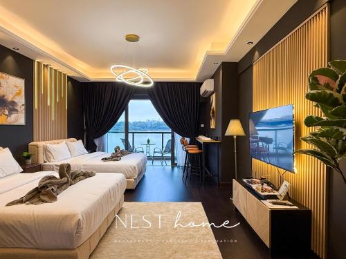 a hotel room with two beds and a balcony at R&F Princess Cove by Nest Home at Johor Bahru in Johor Bahru