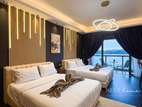 a hotel room with two beds and a balcony at R&F Princess Cove by Nest Home at Johor Bahru in Johor Bahru