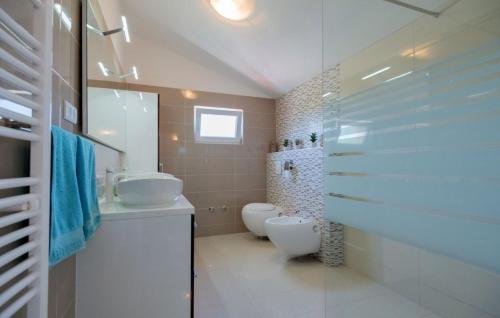 a bathroom with two sinks and a toilet and a shower at Villa Drazana - Makarska by Villas Guide in Perići