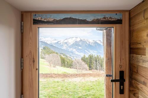 a door with a view of a mountain view at Le petit érable - Vue Mont Blanc in Villard-sur-Doron