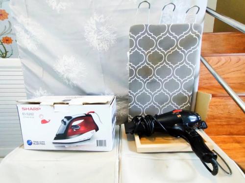 a pair of scissors sitting next to a box at Nana hostel in Nakhon Phanom