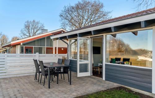un patio con tavolo e sedie accanto a una recinzione di Holiday Home Aabenraa With Fireplace 11 a Aabenraa