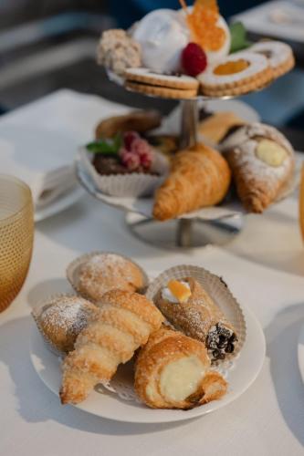 a table with a plate of pastries and other desserts at Emme Palace Hotel & Spa in Orvieto