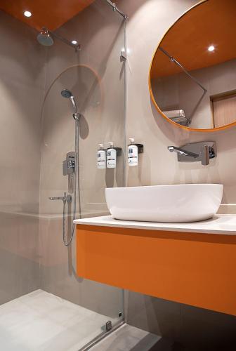 a bathroom with a sink and a mirror at Nest By TreeHouse Bhiwadi in Bhiwadi