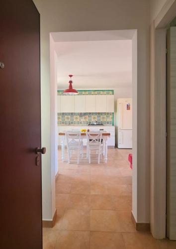 a kitchen and dining room with a table and chairs at Ariammare - small penthouse in Grottammare