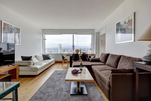 un salon avec un canapé et une table dans l'établissement 5019 Suite Pouey - Apartment near La Défense, à Puteaux