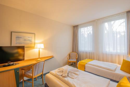 Ένα ή περισσότερα κρεβάτια σε δωμάτιο στο Seehotel Bollmannsruh